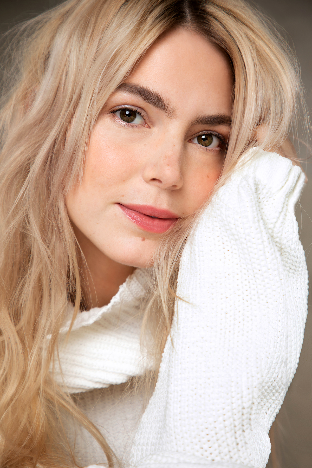 Alyson Gorske in a close-up headshot, wearing a white knit sweater and looking directly at the camera.